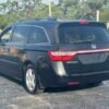 Horizontal photograph of a 2013HondaOdysseyTouring Elite Minivan 4D