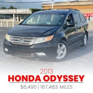 Horizontal photograph of a 2013HondaOdysseyTouring Elite Minivan 4D