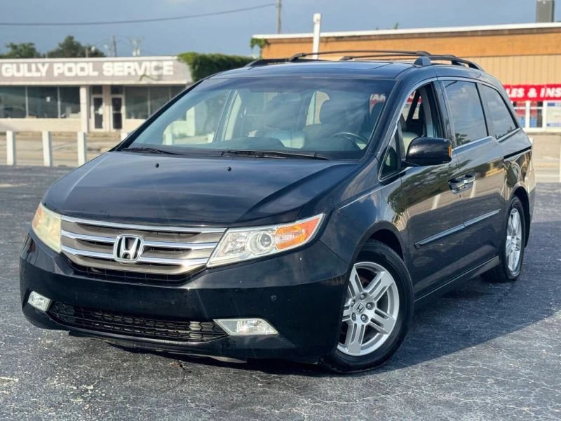 Horizontal photograph of a 2013HondaOdysseyTouring Elite Minivan 4D